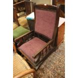 An early 20th century rocking chair with reeded frame and velour padded seat and back