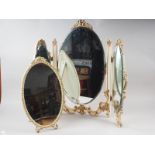 A pair of ornate brass framed circular wall mirrors, a convex wall mirror in cream and gilt frame, a