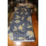 A pair curtains with floral designs on a blue ground, 50" drop x 108" wide