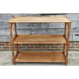 A late 19th century oak three-tier buffet, on turned supports, 48" wide x 17 1/2" deep x 39" high