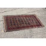 A Caucasian rug decorated four rows of stylised star designs on a brown field with four border