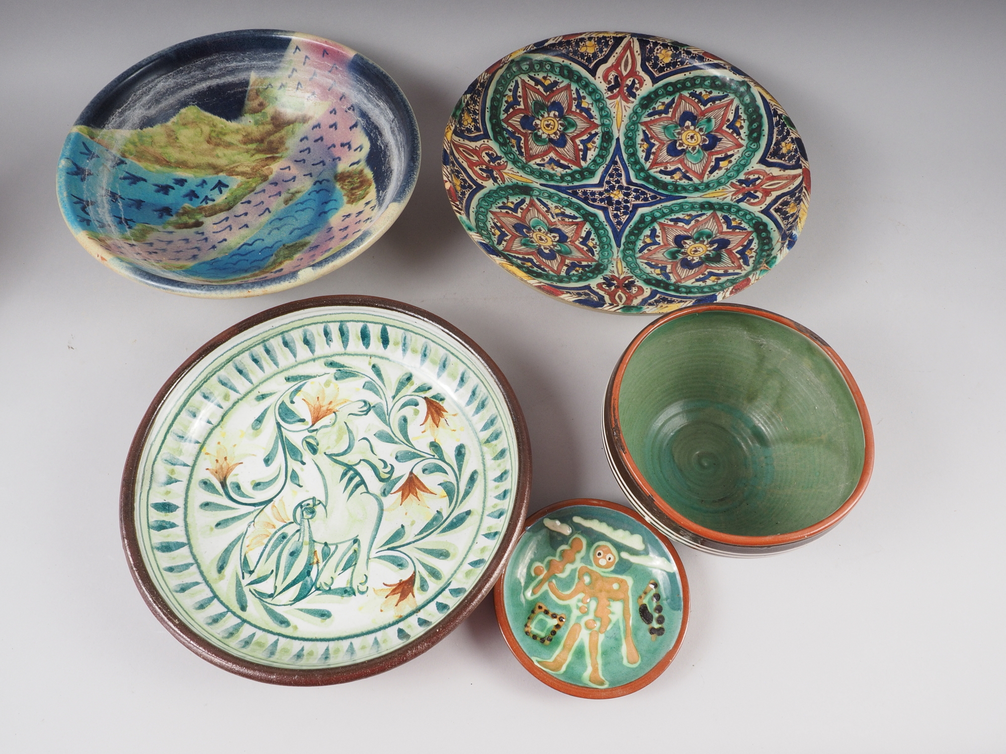 An assortment of studio pottery dishes, a Winstanley seated cat ornament, etc