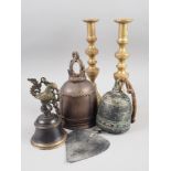 A pair of brass ejector candlesticks and three bronzed bells