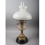 A Victorian pedestal oil lamp, on brass column