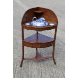 An Edwardian bowfront corner washstand, fitted single central drawer with Minton blue transfer