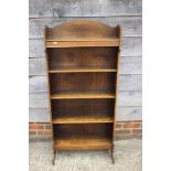 An Art Nouveau oak narrow open bookcase, fitted five shelves, on panel end supports, 24" wide x 11