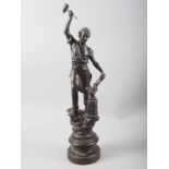 A spelter figure of a blacksmith, on turned wood base, 19" high