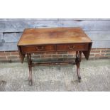 A mahogany and line inlaid sofa table, fitted two drawers, on lyre end supports and splay feet,