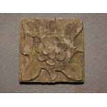 An antique carved stone tile with floral design, 9 1/4" square