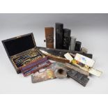 An assortment of 19th century black metal paint boxes, a palette and a parallel ruler