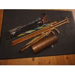 Four umbrellas of various sizes, four walking sticks, a shooting stick, a brass stick stand, 20"