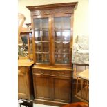 A Frank Hudson walnut bookcase of Georgian design, the upper section enclosed glazed panel doors