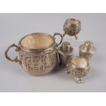 A Persian white metal two-handled sugar bowl, a pair of Persian white metal pepper shakers and a