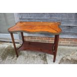 A 19th century mahogany shaped top side table with kingwood banded border and brass edging, on