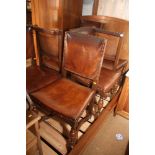 A set of six oak standard dining chairs of Restoration design with leather seats and backs, on