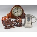 A 20th century mantel clock in mahogany case, a pair of Chinese carved wooden buffalo models and a