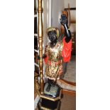 A carved and painted wood blackamoor single-light candelabrum, on plinth base