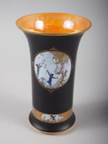 A Carltonware "Fairy" flared rim vase, decorated panels on a black ground with gilt borders and