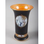 A Carltonware "Fairy" flared rim vase, decorated panels on a black ground with gilt borders and