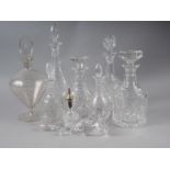 A double ring necked cut glass decanter, four other decanters, two scent bottles with matched