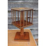 An Edwardian mahogany and fan paterae inlaid revolving bookcase, on stand, 11" square x 22" high