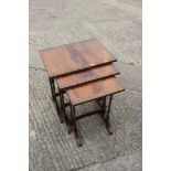 A nest of three mahogany and banded tea tables, on slender turned supports, 19 1/2" wide x 13 1/2" x