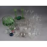 An assortment of drinking glasses, paperweights, and other decorative glassware