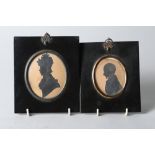 An early 19th century cut paper silhouette of an unknown gentleman, 2 3/4" x 2 1/4", in oval mount