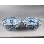 Two Chinese blue and white bowls with dragon, wave and cloud decoration with six character marks