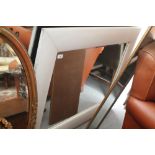 A cream leather framed rectangular wall mirror, 45" x 34" overall