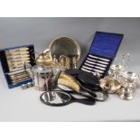 A cased set of six silver handled tea knives, a silver tea strainer and stand, a plated cruet and