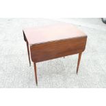 An early 19th century mahogany Pembroke table, fitted one drawer, on slender square tapered