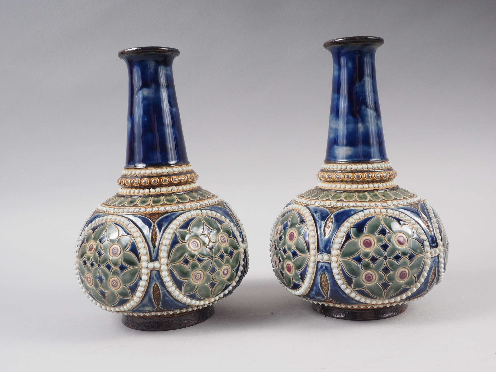 A pair of Royal Doulton blue and green glazed bottle vases, 9" high, and a pair of Doulton