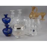 A latticino decorated glass jug and two matching glasses, a pair of frosted glass candlesticks and