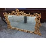 A Brights of Nettlebed rectangular gilt framed wall mirror with ornate scrolled and pierced