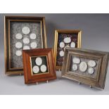 Twenty five 19th century plaster medallions, in four frames