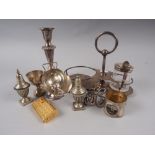 A silver plated candlestick, 6 3/4" high, a pair of silver plated pepperettes, a gold plated