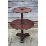 An early 19th century Irish? mahogany two-tier dumb waiter, on shaped triangular platform base,