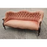 A late Victorian carved walnut showframe settee with loose seat cushions, upholstered in a rust