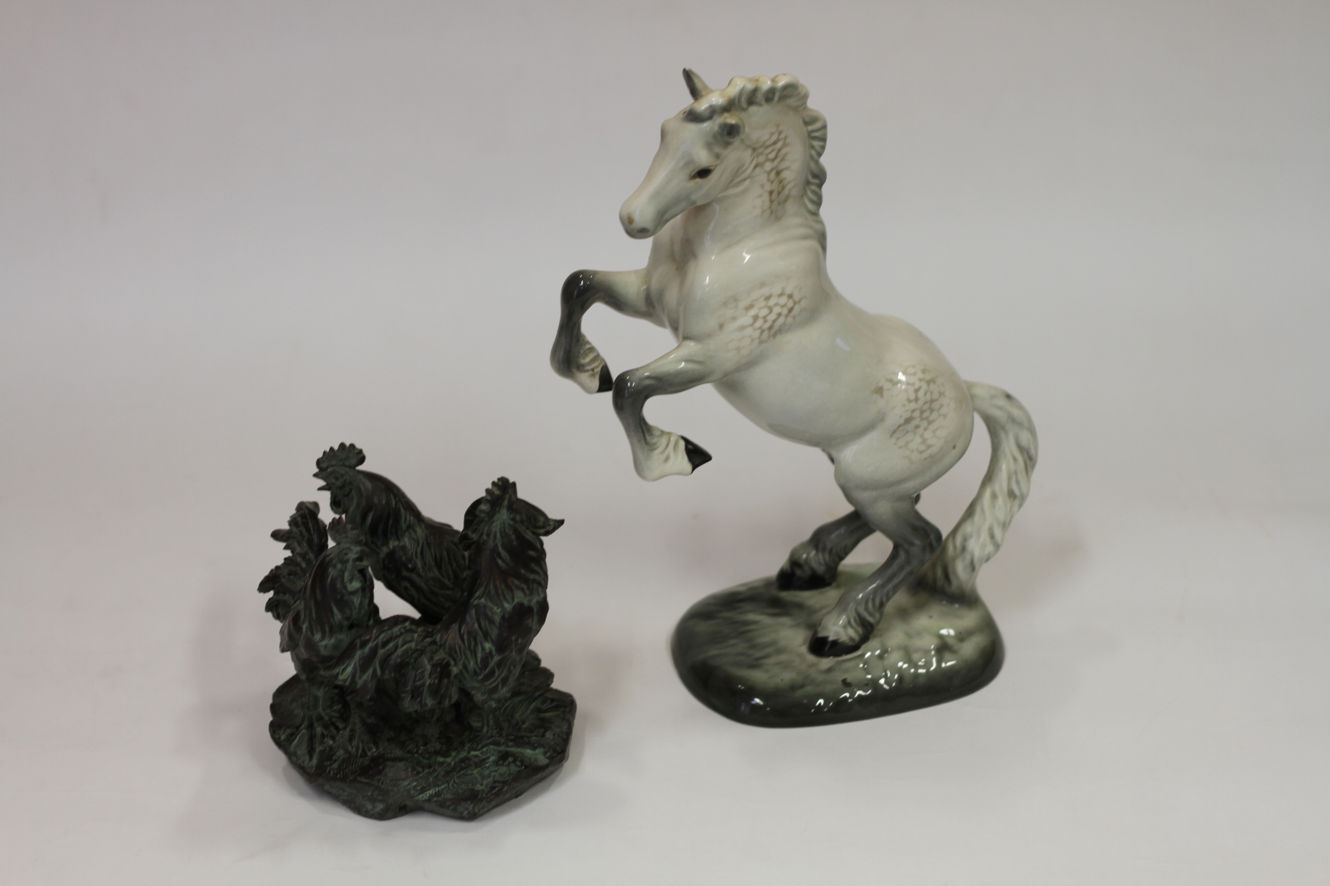 A Beswick grey cob, rearing model 1014, 10 1/2" high and a composition model of three crowing cocker