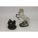 A Beswick grey cob, rearing model 1014, 10 1/2" high and a composition model of three crowing cocker