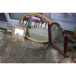 An arched top swing frame mirror, an oval bevelled wall mirror, in gilt frame, and a smaller