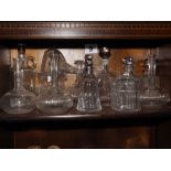 Ten assorted glass decanters, one with silver neck, a glass jug and a biscuit barrel