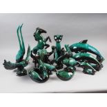 A collection of fourteen green and black glazed models of animals, tallest 16" high