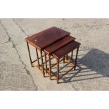 A late 19th century mahogany nest of tables, on barley twist supports, and a mahogany shaped top