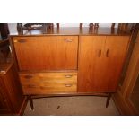 An E. Gomme teak sideboard with pair of cupboard doors and drop down cupboard door over two long