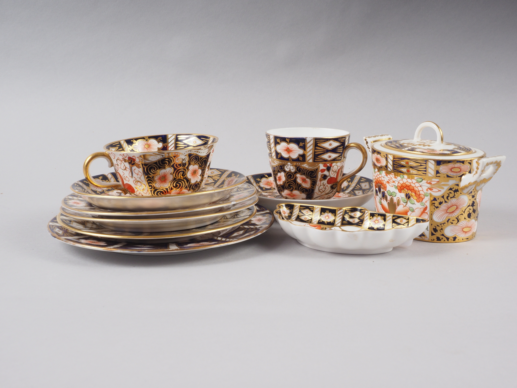 A pair of Royal Crown Derby cups, pattern 2451, six matching saucers, a similar pin dish and a