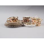 A pair of Royal Crown Derby cups, pattern 2451, six matching saucers, a similar pin dish and a