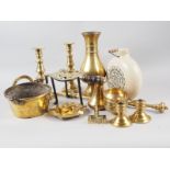 A pair of brass candlesticks, a stoneware hot water bottle and assorted decorative brass items