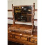 A Victorian rectangular figured mahogany swing frame toilet mirror with turned columns, on plateau